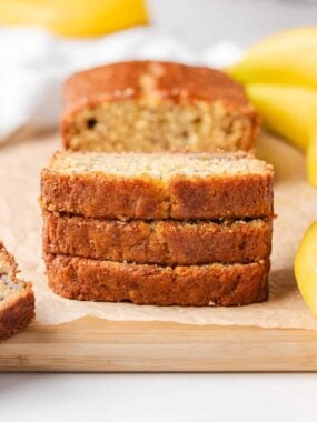 Thick slices of banana sour cream bread with a golden crust and soft center.
