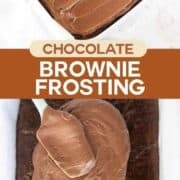 Brownie frosting on a pan of brownies.