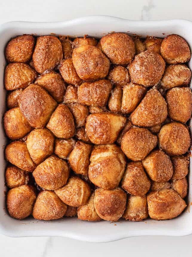 These easy cinnamon roll bites deliver soft, fluffy cinnamon sugar goodness in a bite-sized treat made with ready-made frozen dough. They're perfectly gooey for a sweet treat! Freshly baked cinnamon roll bites with golden brown tops.
