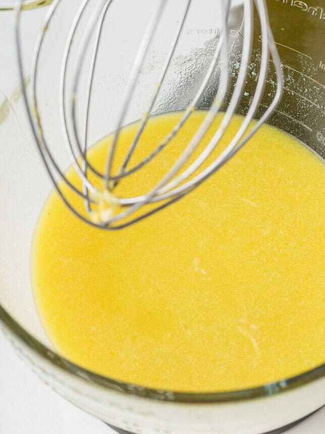 This lemon olive oil cake is sunshine in dessert form, with a light, tender crumb and bright lemon flavor in every bite. Elegant yet simple, it’s an effortless cake to make. Olive oil and lemon mixture whisked together for lemon olive oil cake batter.