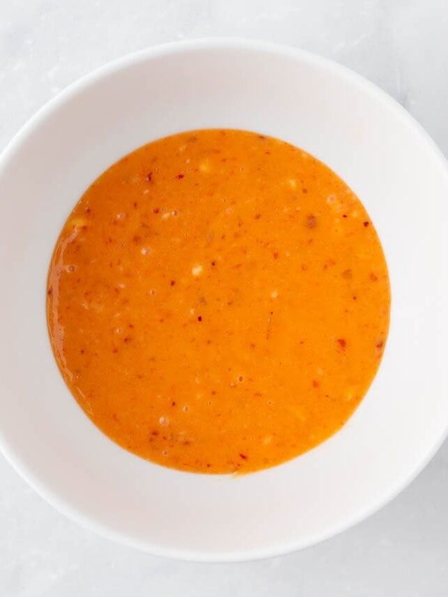Bang bang sauce mixed together in a white bowl.