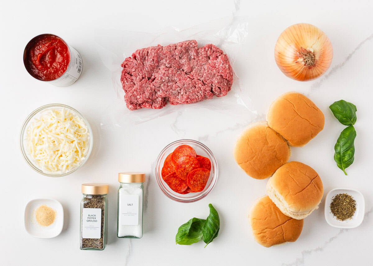 Bite into simpler times with old-school open faced pizza burgers made with seasoned ground beef on a toasted bun, smothered in tomato sauce, melty cheese, and pepperoni! Ingredients for pizza burgers including ground beef, pizza sauce, shredded mozzarella, hamburger buns, onion, pepperoni, and seasonings.