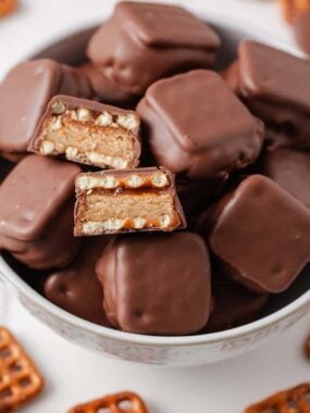 Close-up overhead angle of copycat take 5 candy bars, with two halved pieces showing the chewy, crunchy layers inside.