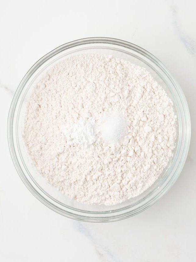 Flour, baking powder, and salt whisked together in a glass bowl.