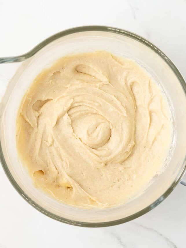 Smooth classic pound cake batter in a stand mixer bowl.