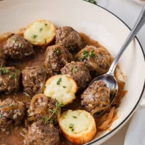 French onion meatballs in a savory onion gravy with cheesy toasted baguette slices.