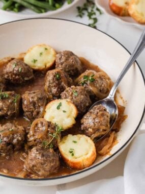 French onion meatballs in a savory onion gravy with cheesy toasted baguette slices.