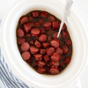 Brown sugar kielbasa bites cooked in a slow cooker until sticky and glazed.