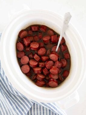 Brown sugar kielbasa bites cooked in a slow cooker until sticky and glazed.