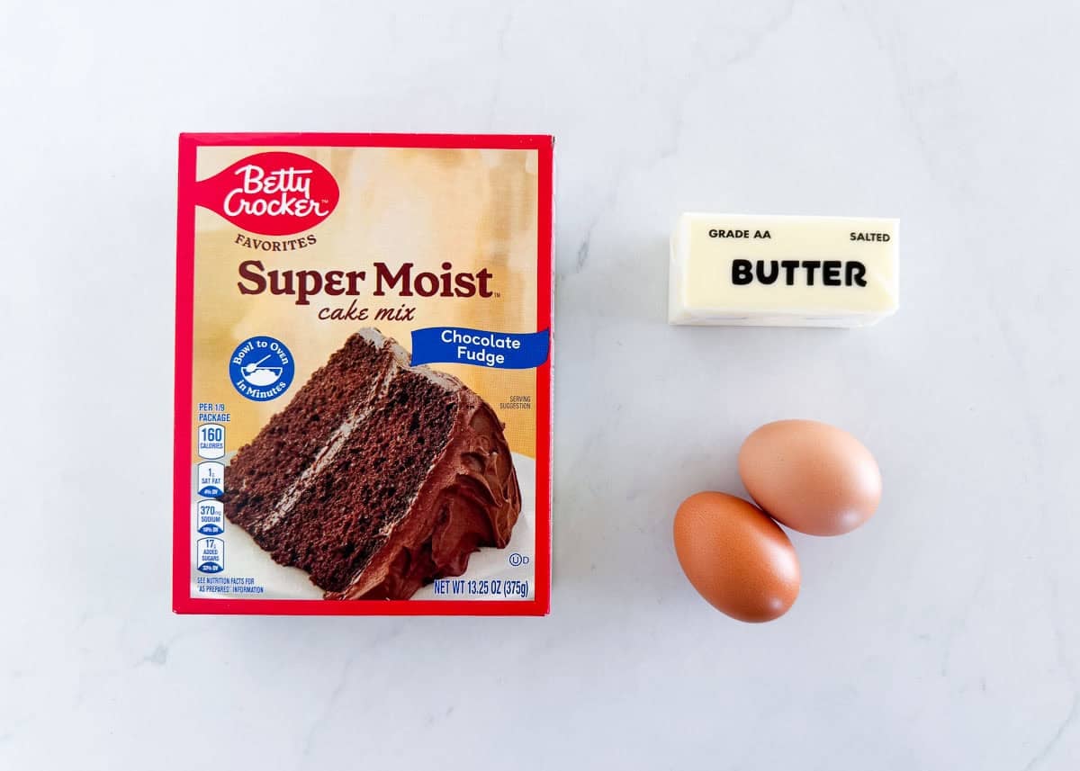 Chocolate cake mix cookie ingredients including chocolate cake mix, butter and two eggs.