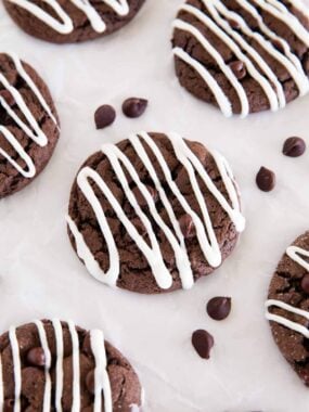 Soft chocolate cake mix cookies covered with white chocolate drizzle and chocolate chips.