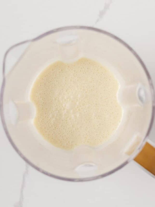 Crepe batter blended smooth in a glass blender jar.