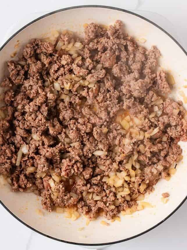 This easy one-pan skillet lasagna comes together on the stovetop in under an hour, with the same bubbly, saucy, cheesy comfort of the classic baked version. Browning Italian sausage with diced onion in a skillet for easy weeknight skillet lasagna.