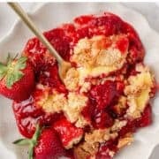 Strawberry cheesecake dump cake in a bowl.
