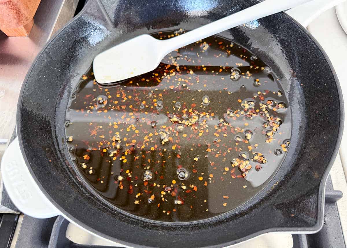 Making sauce for thai pasta salad in a skillet.