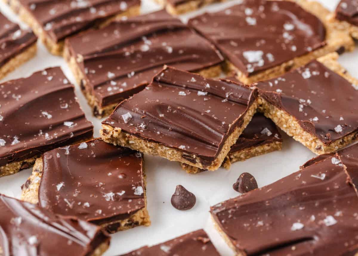 Homemade cookie dough bark squares with a chocolate topping, oat cookie dough layer and flaky sea salt.