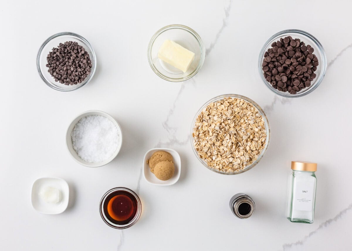 Ingredients for healthy cookie dough bark including oats, chocolate chips, maple syrup, butter, brown sugar and sea salt.