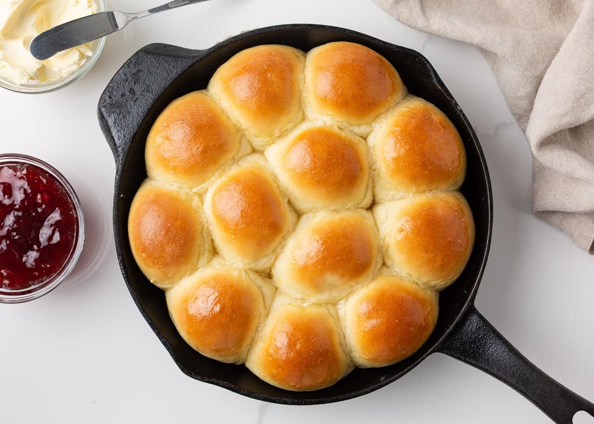 Homemade skillet rolls baked until golden brown and served with butter and jam.