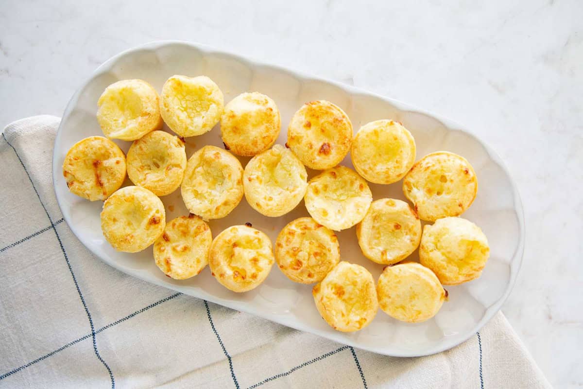 Easy Brazilian cheese bites (Pão de queijo) arranged on a platter for serving.