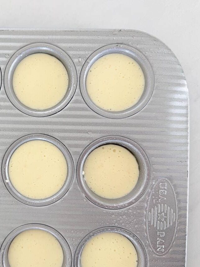 Brazilian cheese bread batter poured into a greased mini muffin pan.