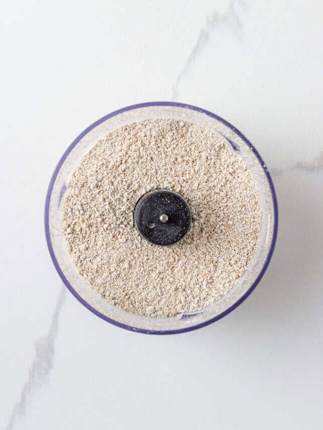 Oats processed into flour in the base of a food processor.