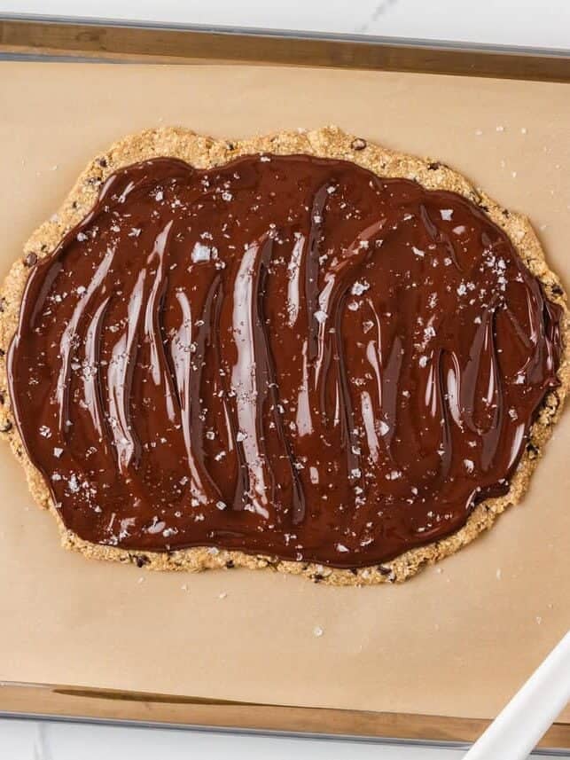 Melted chocolate spread over oat cookie dough bark before freezing.