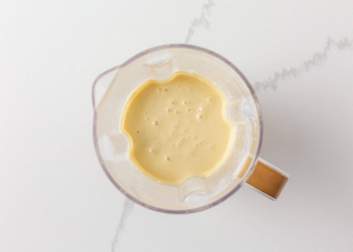 Smooth blended cottage cheese pancake batter inside a blender viewed from above.