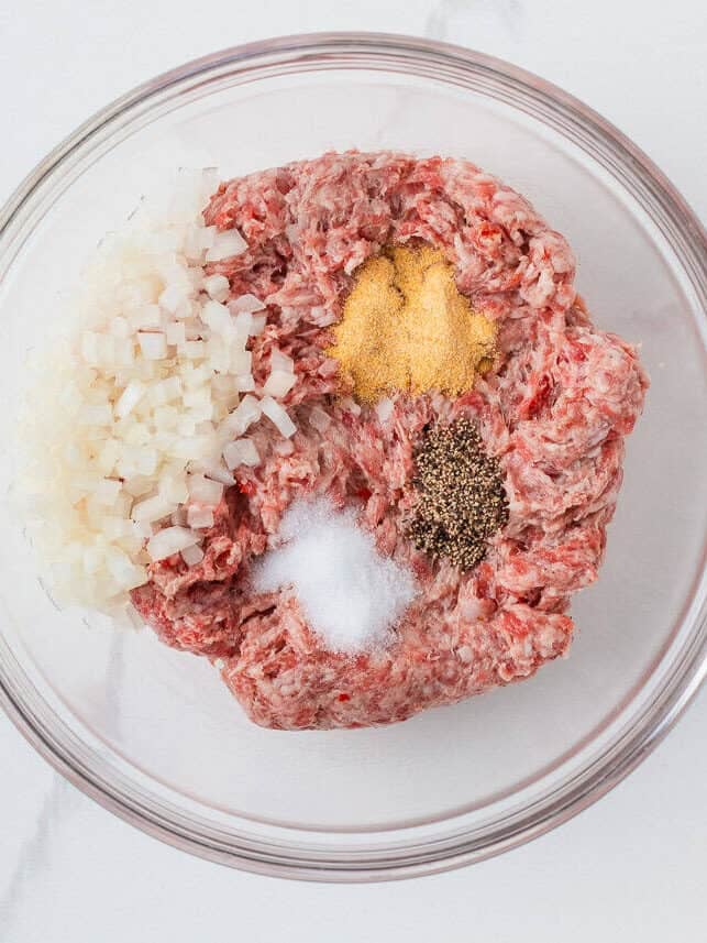 Ground pork mixture with onions and seasonings for homemade sticky pork meatballs.
