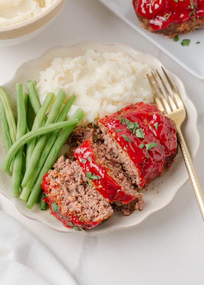 Sliced mini meatloaf on a plate.