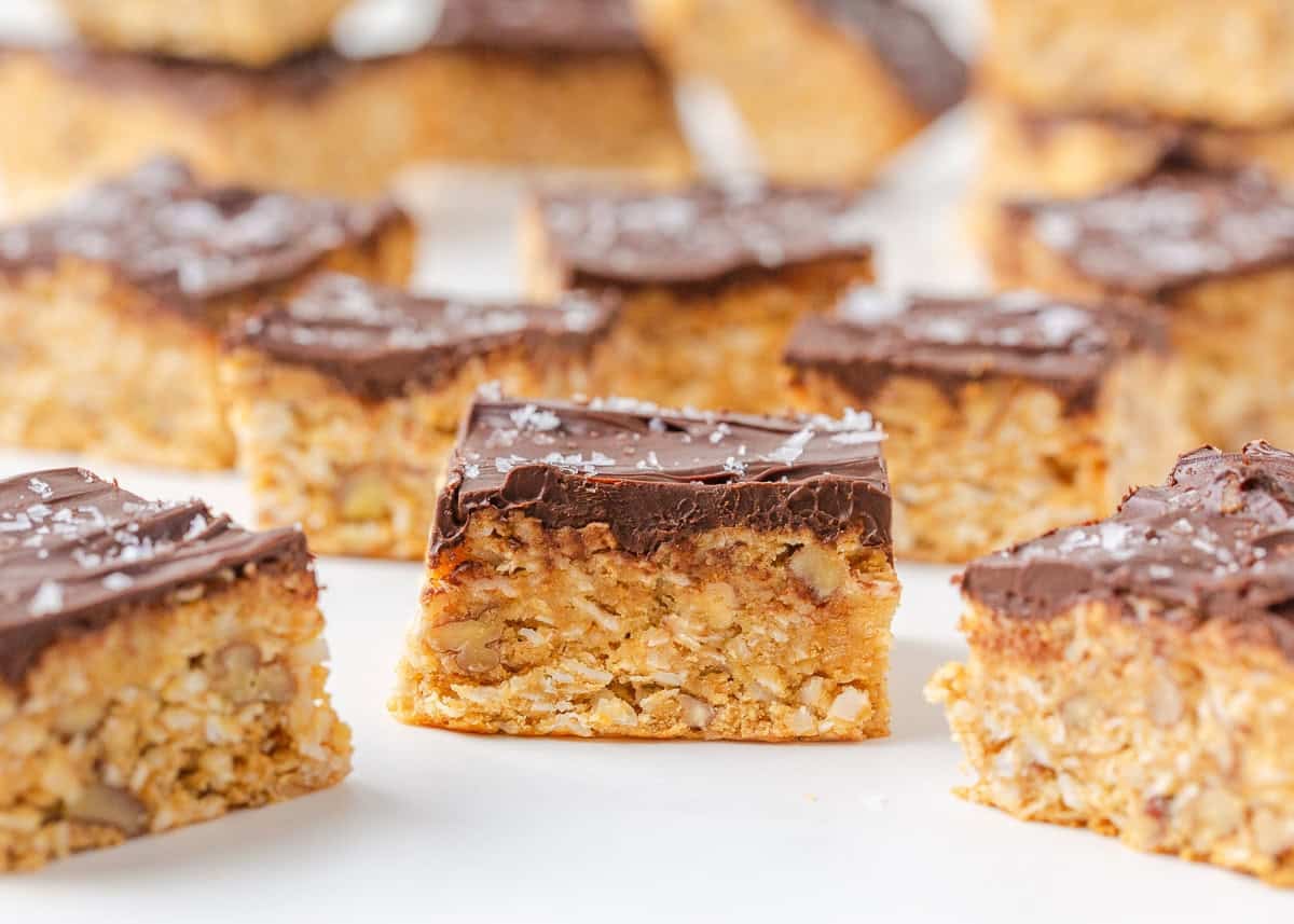 Chocolate-topped 5 star bars arranged on a white surface with one bar centered in front.