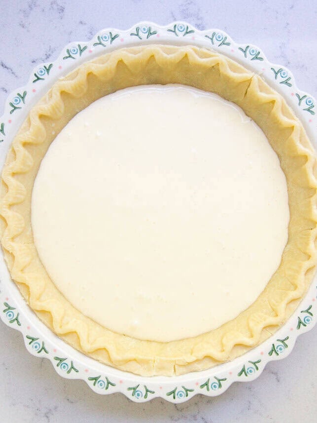 Creamy cheesecake filling layered inside an unbaked pastry pie crust.