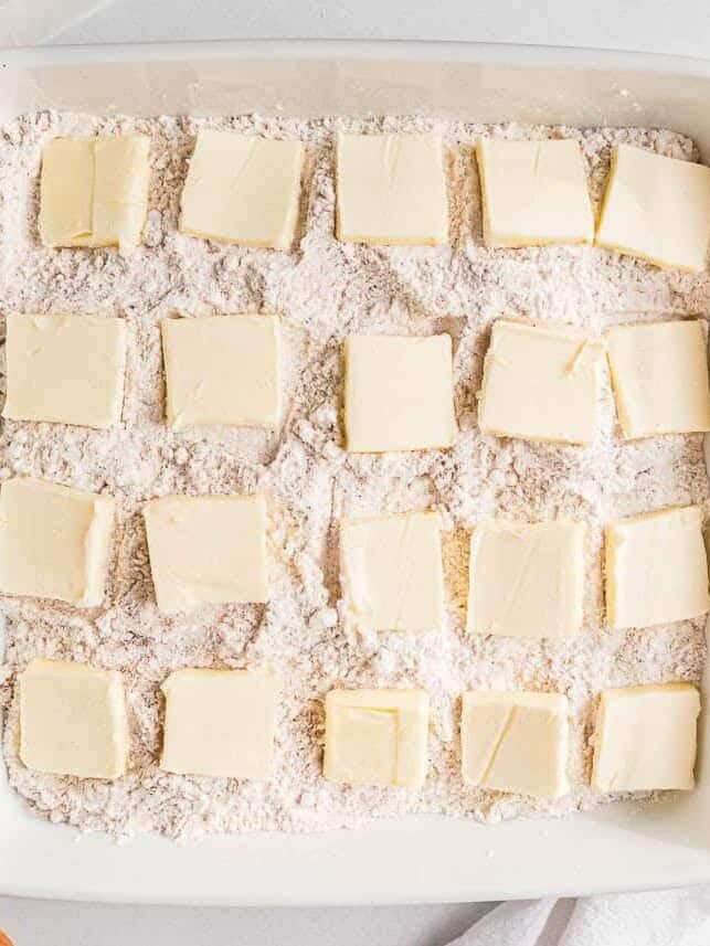 Thin pats of butter spaced evenly across the cake mix topping before baking.