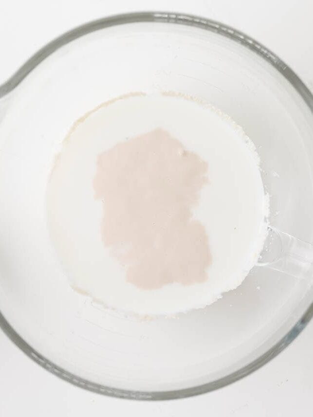 Yeast mixture proofing in warm milk for apple fritter dough.