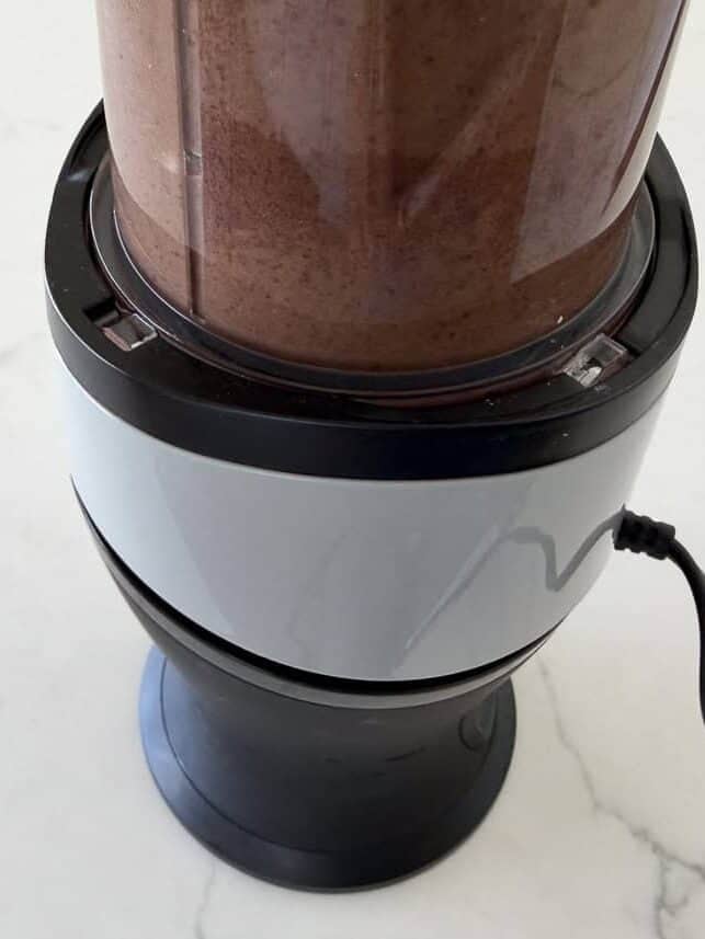 Portion of black bean soup blended until smooth in a blender.