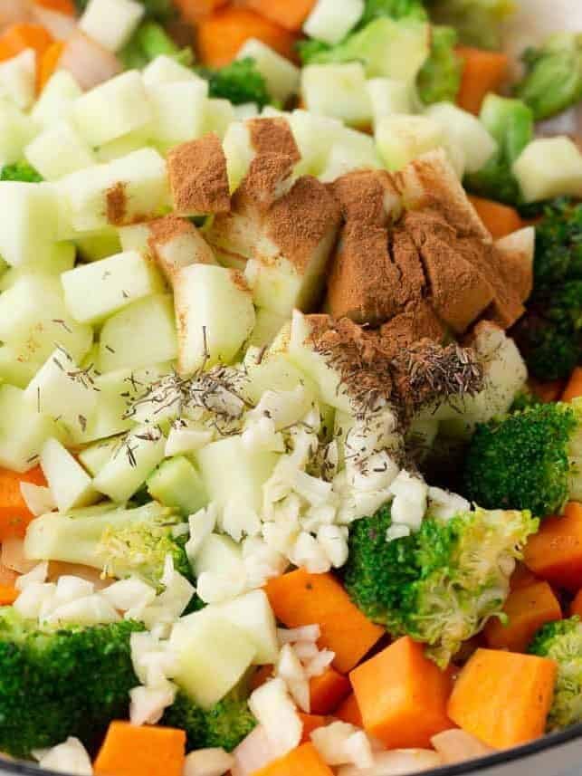 Chopped apples, sweet potatoes and broccoli in a skillet with garlic, cinnamon and thyme.