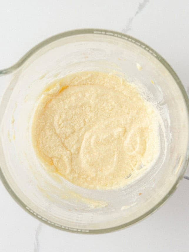 Butter, sugar, eggs and extracts mixed together for Crumbl sugar cookie dough.