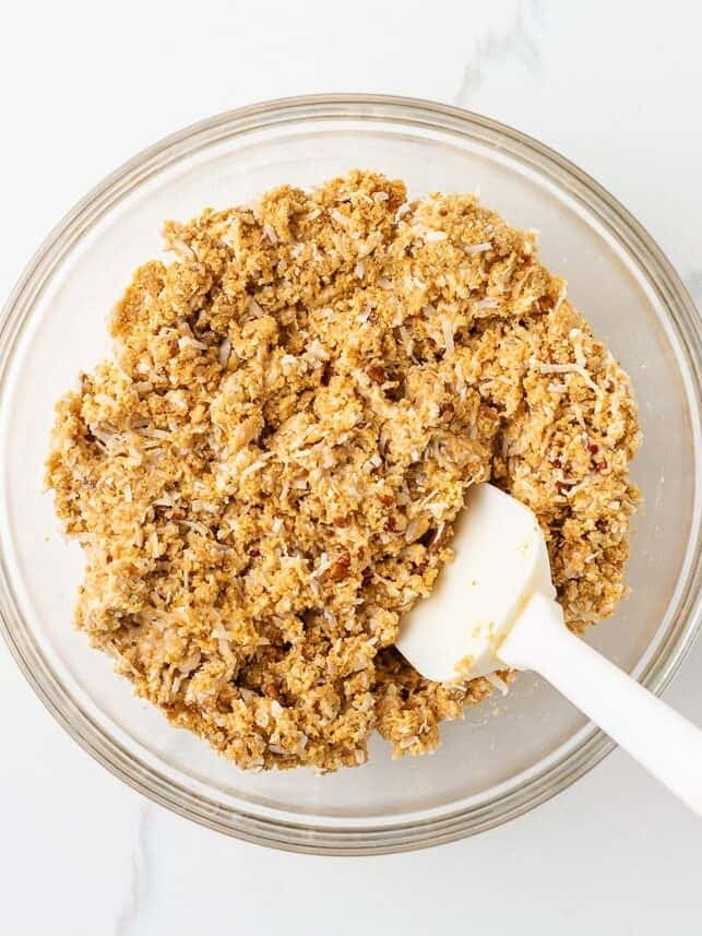 5 star bar mixture stirred together in a glass bowl with a white spatula.