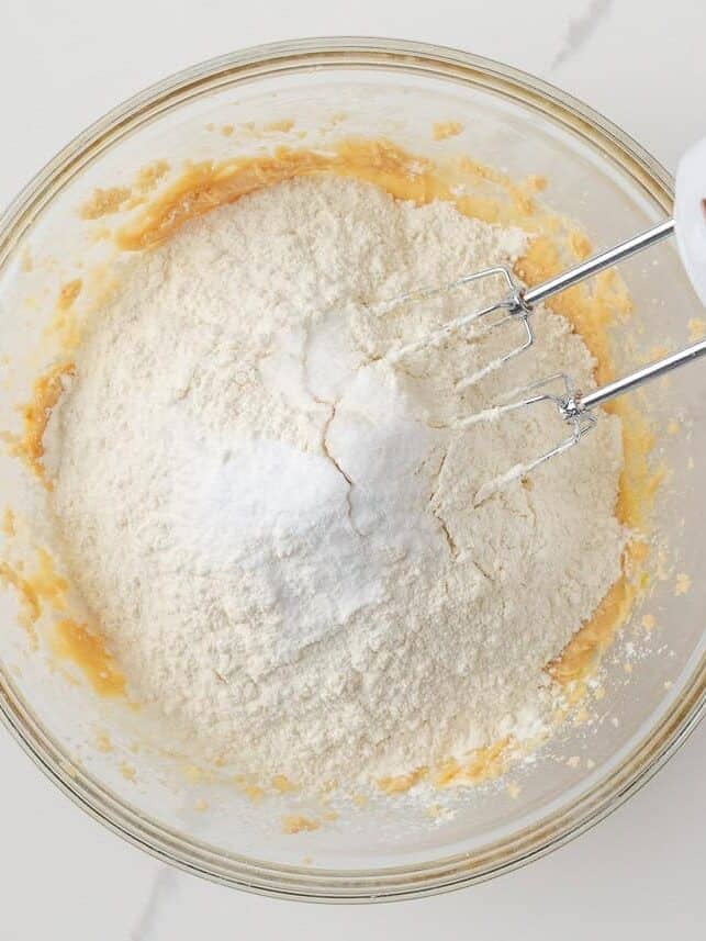Flour, baking soda and salt added to the wet ingredients for candy cookie dough.