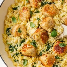 One-pan chicken meatballs with creamy orzo, spinach, Parmesan and basil.