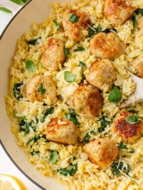 One-pan chicken meatballs with creamy orzo, spinach, Parmesan and basil.
