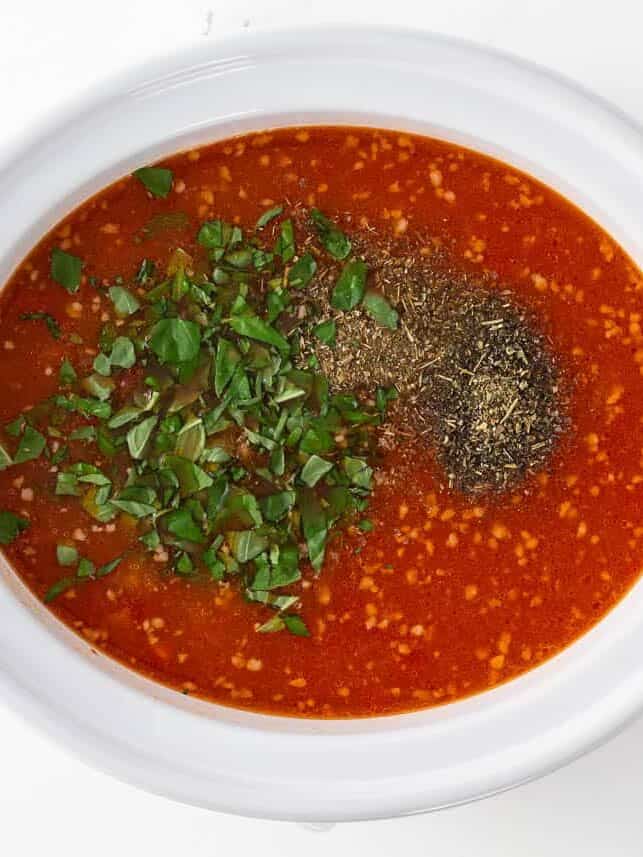 Crockpot lasagna soup ingredients in slow cooker.