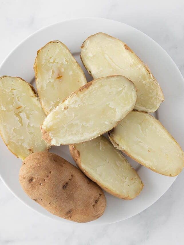 Baked potatoes on a white plate.