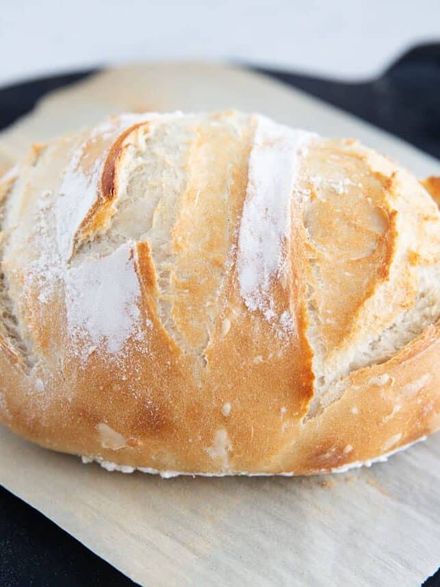 Baked 3 Ingredient bread resting on an artisan baking stone.
