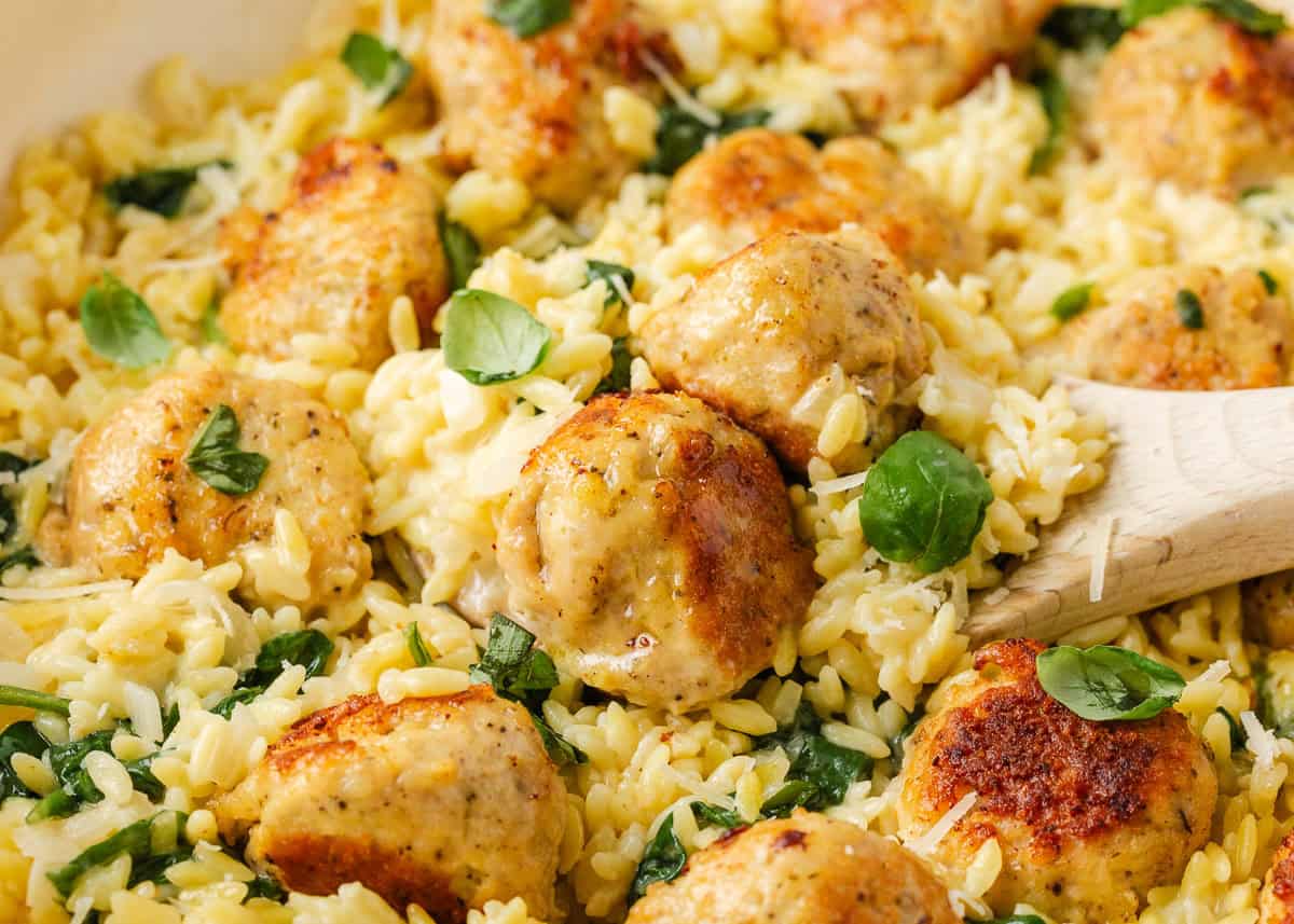 Golden chicken meatballs with creamy Parmesan orzo, spinach and fresh basil.