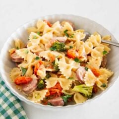 Bowl of creamy Boursin cheese pasta with sausage, broccoli and cherry tomatoes