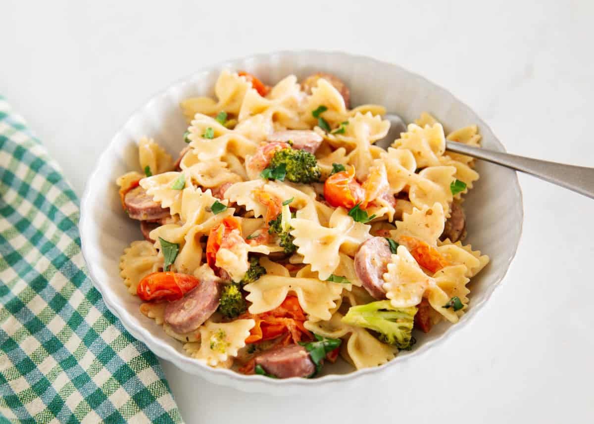 Bowl of creamy Boursin cheese pasta with sausage, broccoli and cherry tomatoes
