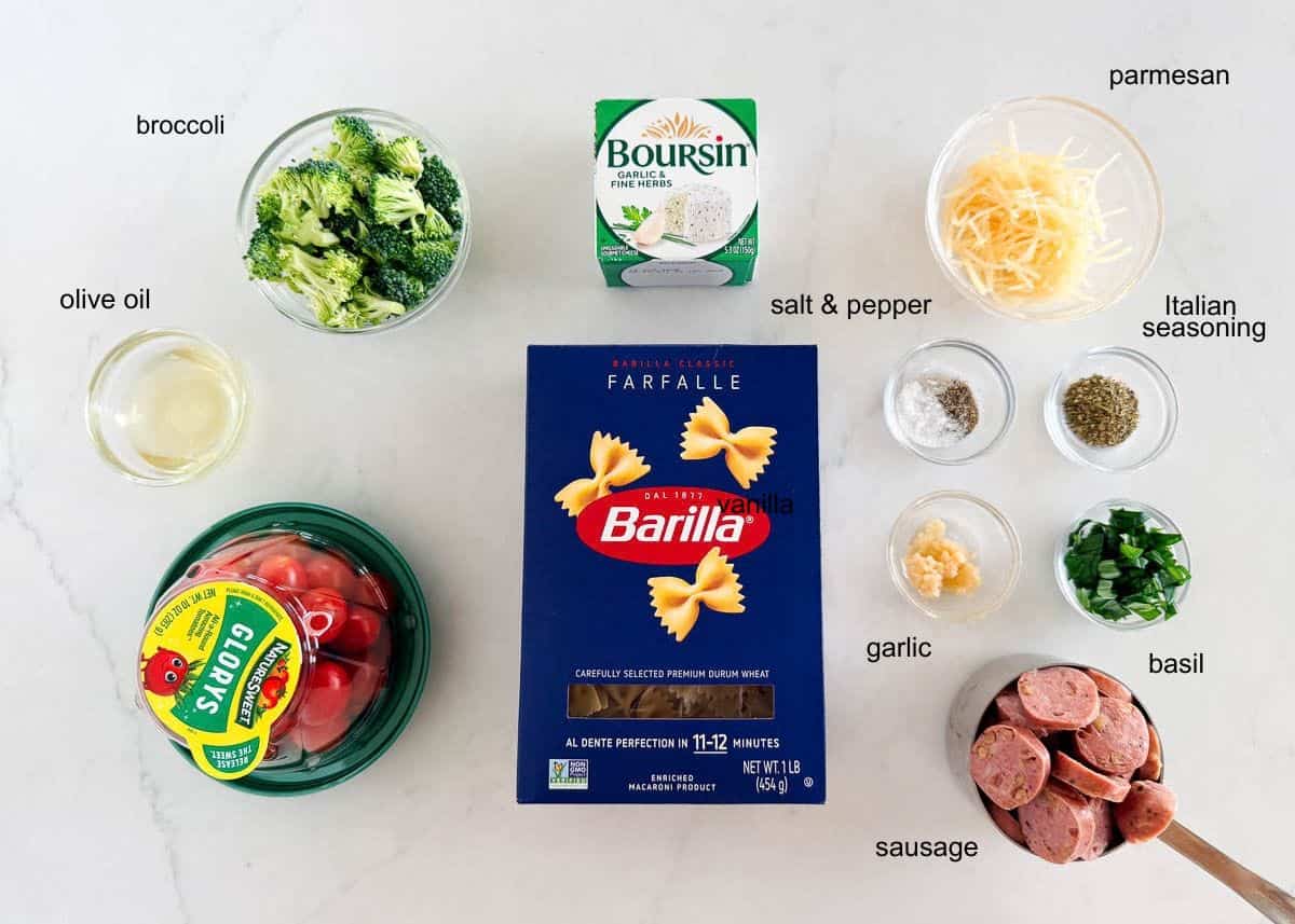 Ingredients for Boursin cheese pasta, including farfalle, sausage, broccoli, tomatoes, Boursin, Parmesan and seasonings.
