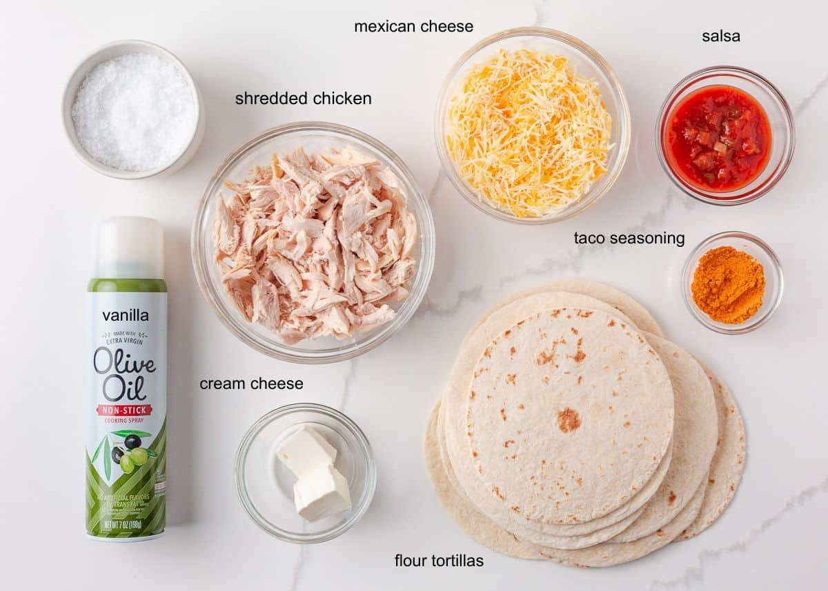 Ingredients for crispy chicken tacos including shredded chicken, cheese, salsa, taco seasoning, cream cheese, salsa, taco seasoning and flour tortillas.