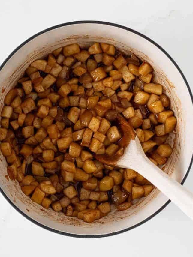 Cooked cinnamon apple filling in a pot ready to spoon into puff pastry turnovers.
