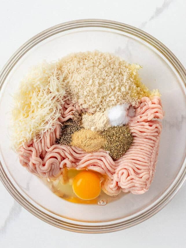 Ground chicken, egg, Parmesan, panko and seasonings in a mixing bowl.